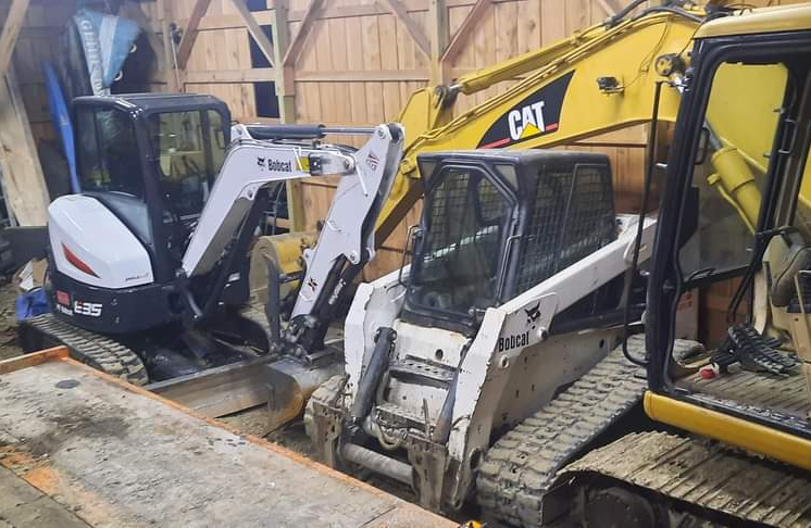 Two white and a large yellow excavation tractor parked, ready to get to work like grading, excavation, Trenching, Drainage, Dredging, etc..
