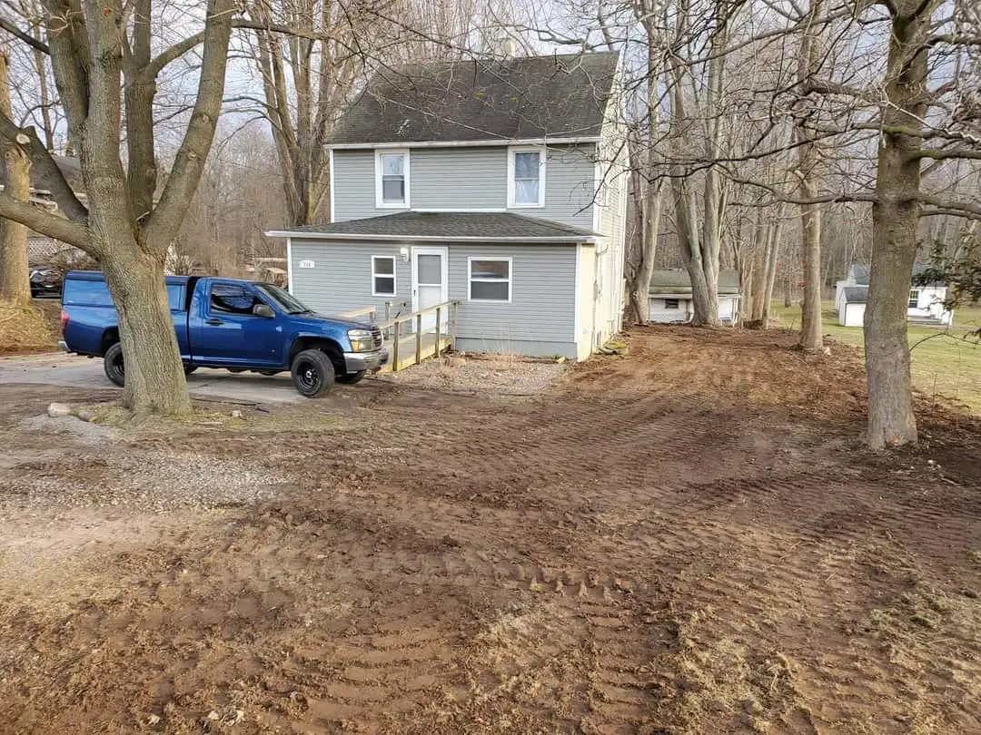 A very nice house along with a van and graded front in front of the house.