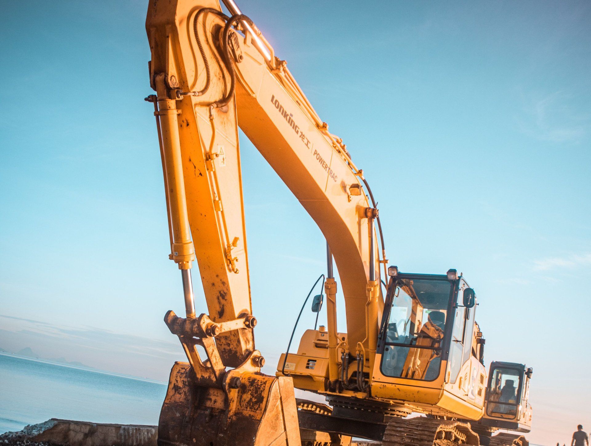 a yellow excavator with the word komatsu on it