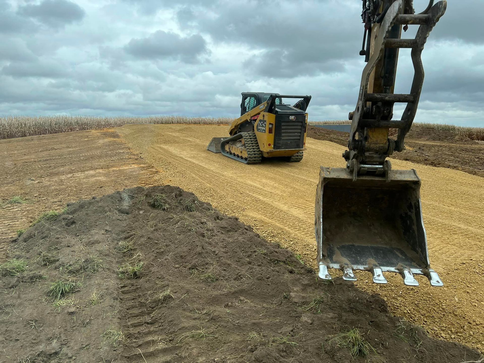 a cat bulldozer is driving down a dirt road