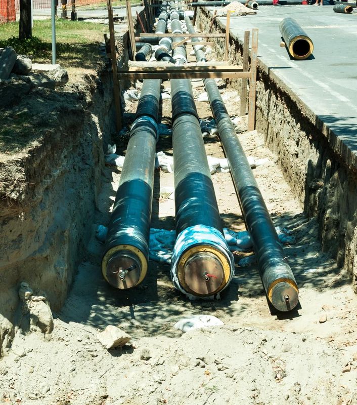 a bunch of pipes are laying in the dirt