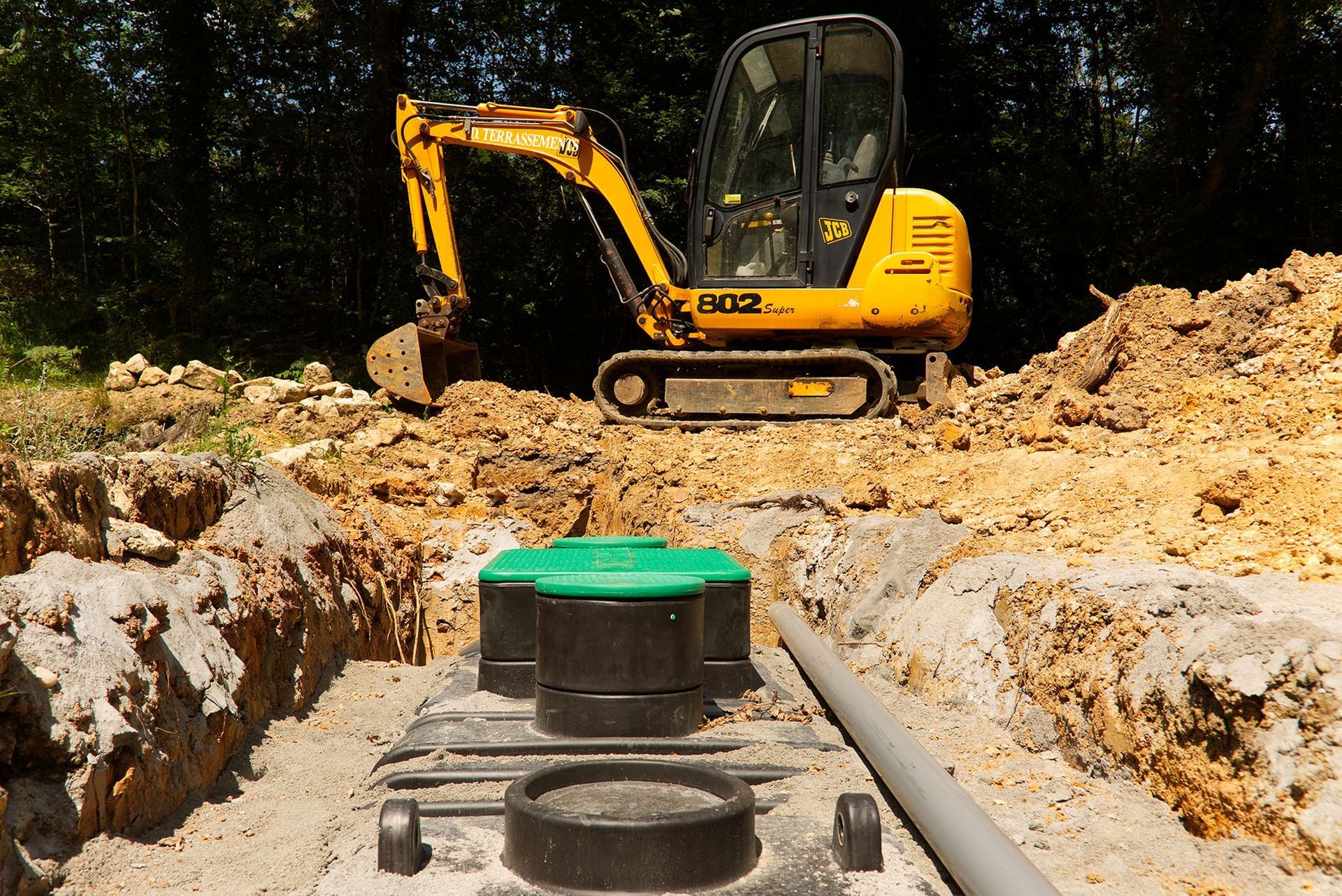 a yellow excavator with the number 802 on it