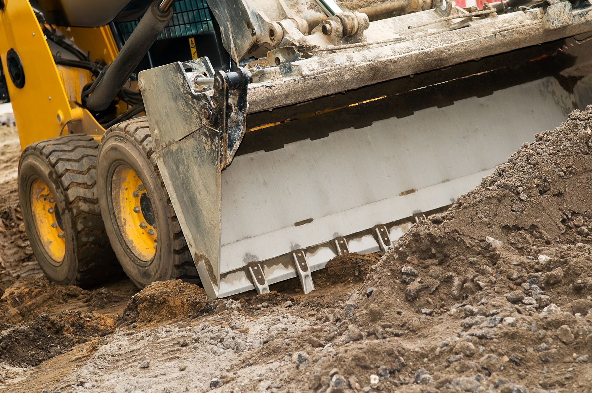 a yellow bulldozer is moving dirt on a construction site