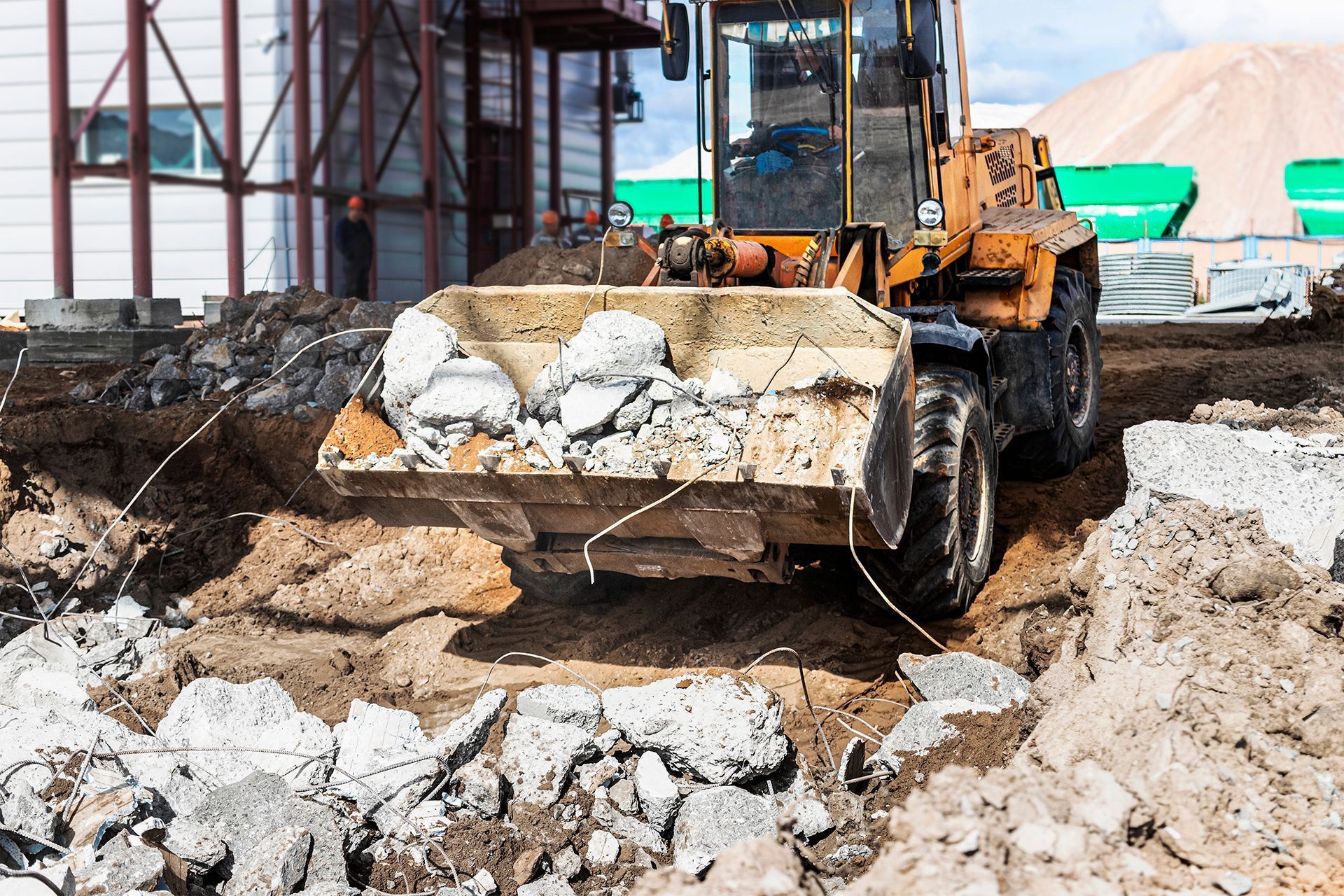 a bulldozer with a bucket full of rocks and dirt